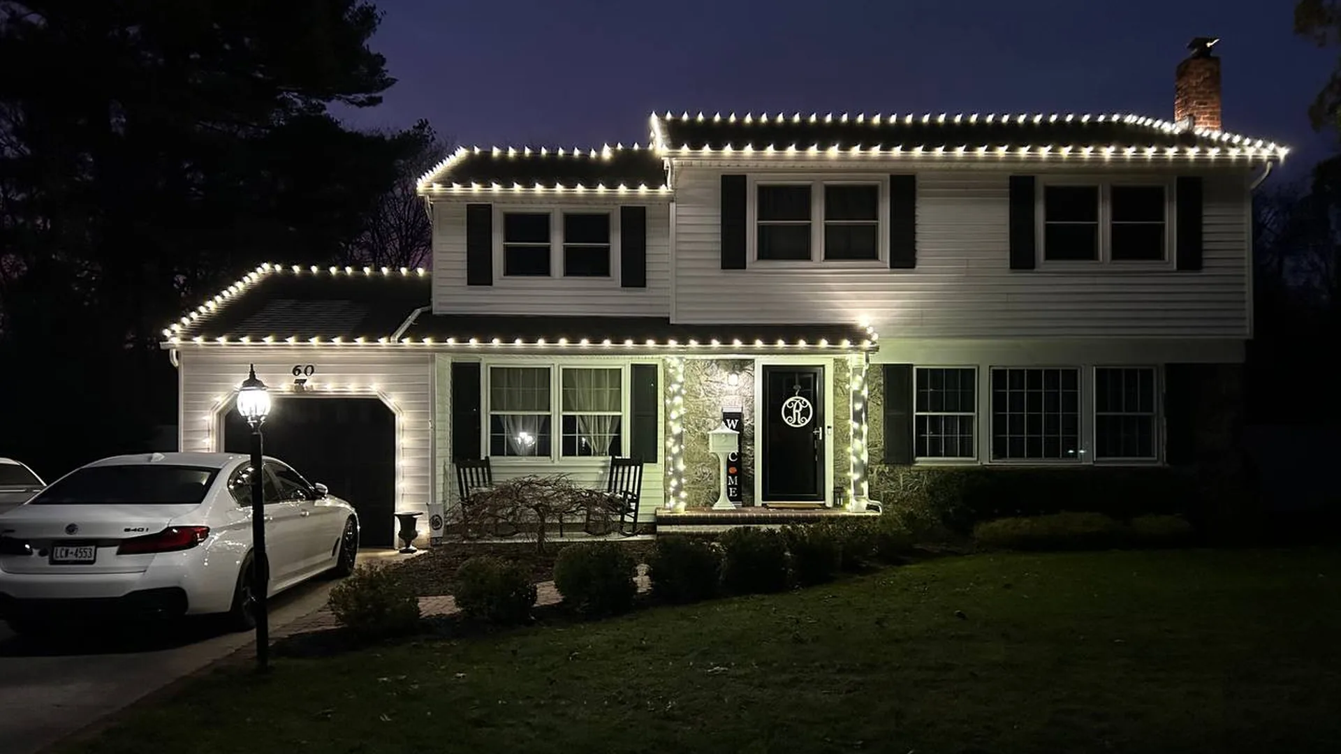 Warm white C9 lights along the roofline of a Long Island colonial